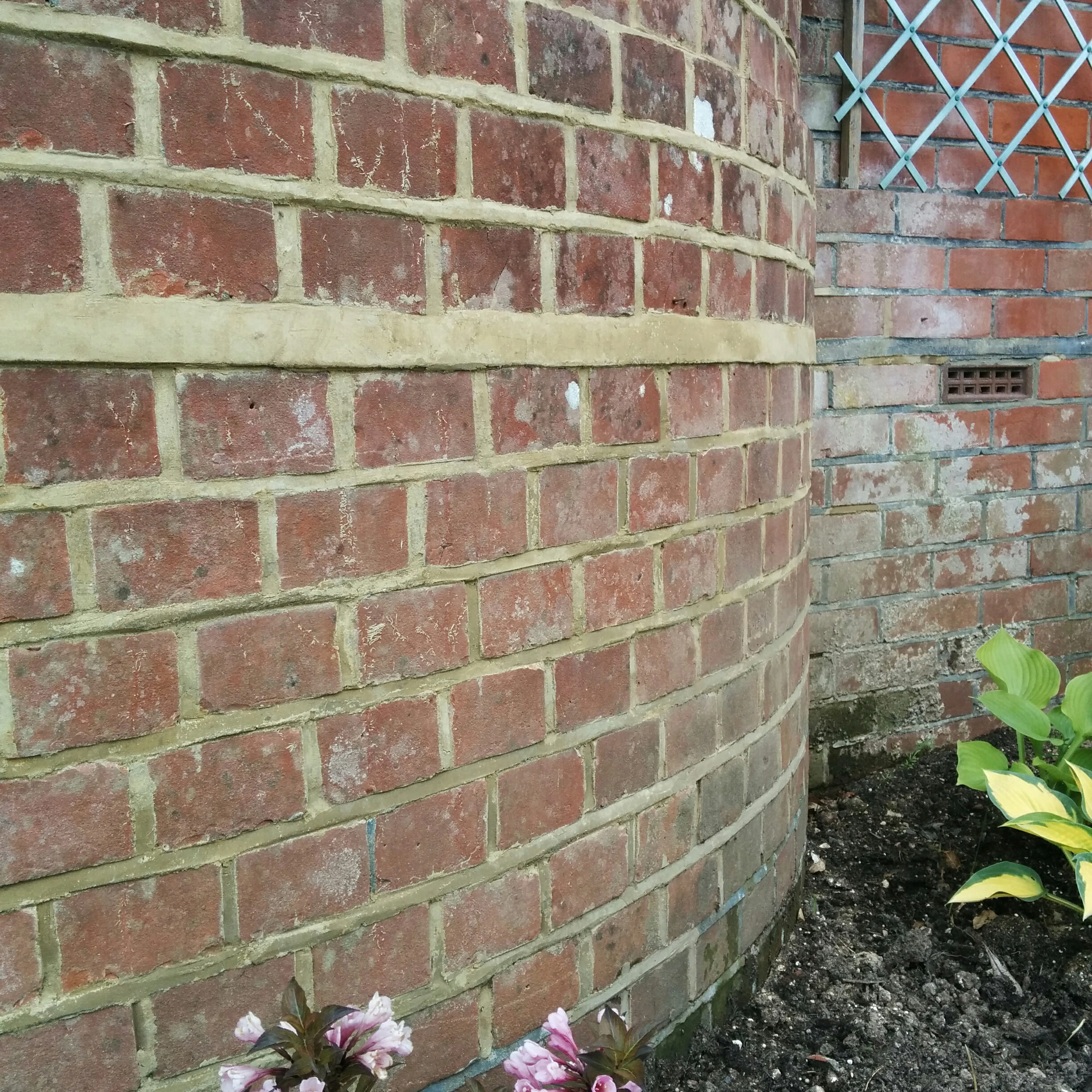 Repointed brickwork under a bay window of a semi-detached house in Maybush, Southampton