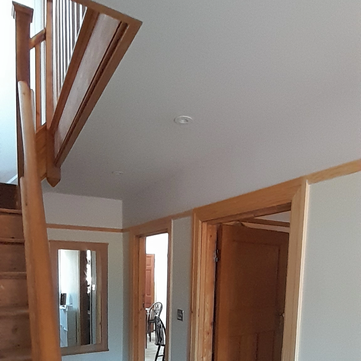 Fully painted and decorated hallway in a Southampton house with natural finish woodwork.