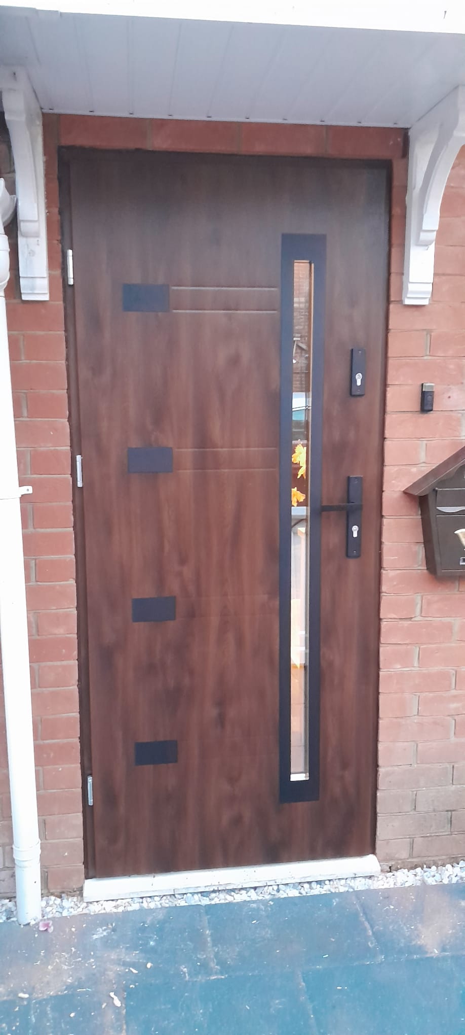 Front Door Installation – Custom Wooden Door with Modern Glass Panel and Black Accents. Recently completed installation for a satisfied customer, featuring a sleek, contemporary design that enhances the home’s curb appeal. Contact us for high-quality front door installations tailored to your style and needs.